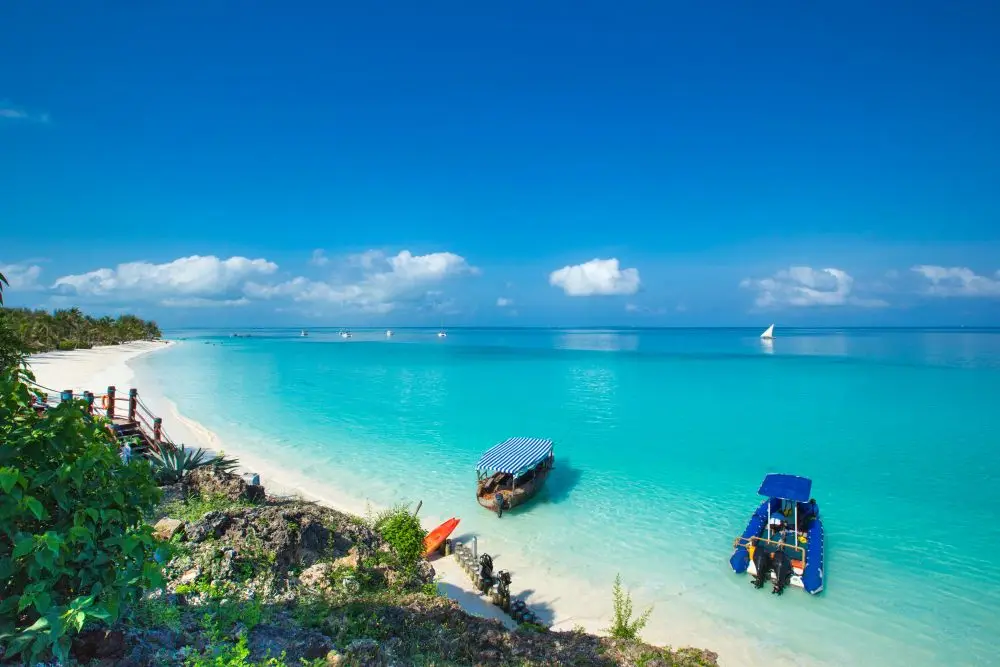 La spiaggia di Zanzibar con la sabbia bianca, la barca e il mare turchese